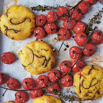 Courgette and pecorino polenta cakes with vine-roasted tomatoes and dry-cured ham