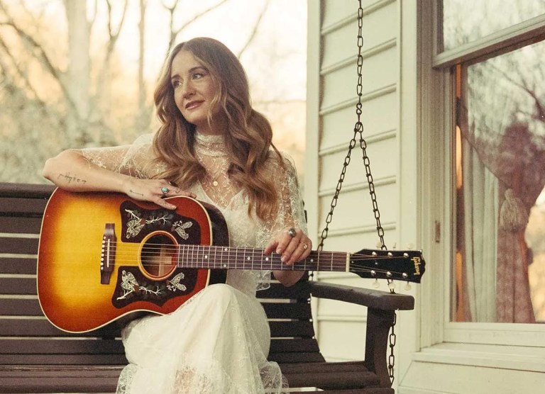 Margo Price on porch swing with signature model Gibson J-45 acoustic guitar, Courtesy of Gibson Brands, Inc.