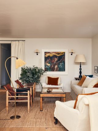 Image may contain Living Room Room Indoors Furniture Couch Flooring Interior Design Chair Wood Hardwood and Table