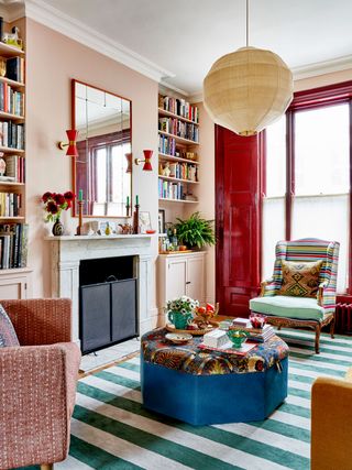 Midcentury Spanish wall lights echo the red of the woodwork in this Lonika Chande project where a ceiling light with a...