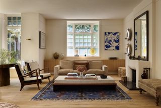 Image may contain Home Decor Architecture Building Furniture Indoors Living Room Room Rug Coffee Table and Table