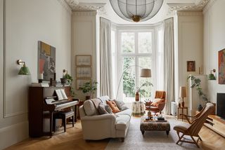 In her airy flat in north London designer Alice Davies has layered every type of lighting with a huge ceiling light that...