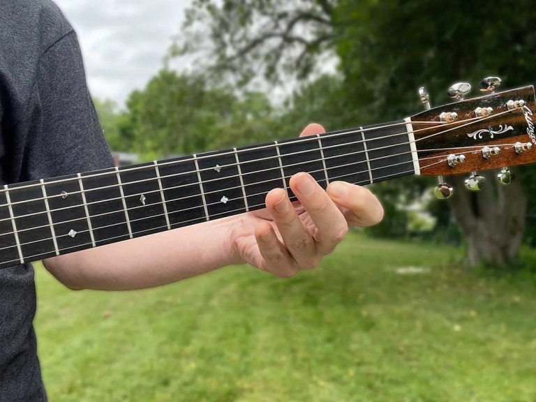 Hand playing notes on an acoustic guitar neck, Courtesy of Jeffrey Pepper Rodgers