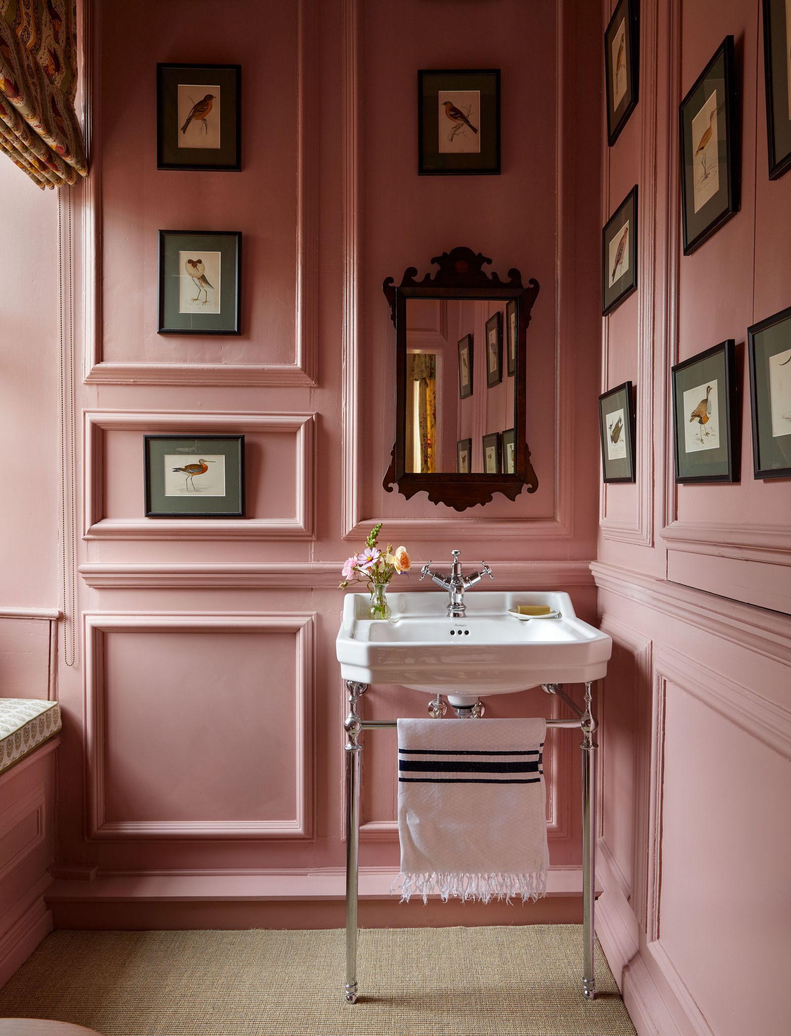 A lovely pink bathroom in a Queen Anne house in Norfolk also designed by Carlos Garcia features walltowall carpeting.