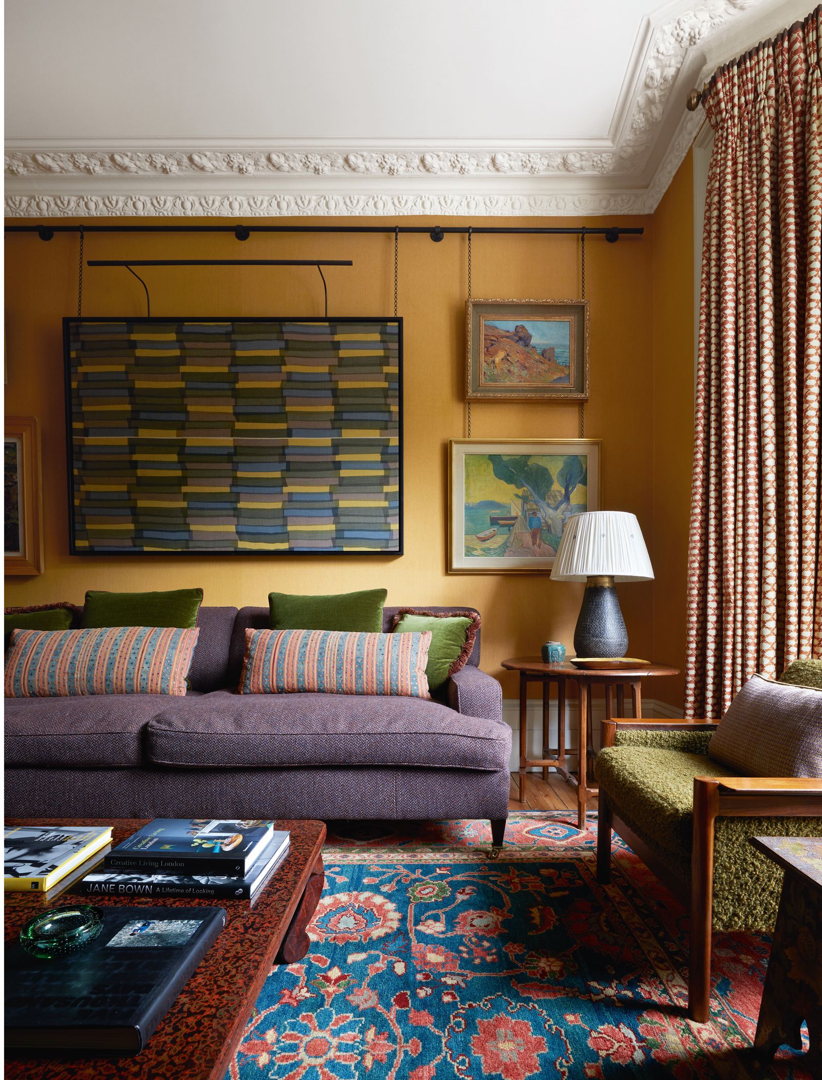 Image may contain Architecture Building Furniture Indoors Living Room Room Home Decor Lamp Couch Art and Painting