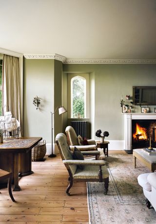 This former vicarage near Bath has characterful layered interiors. In the sitting room deconstructed antique armchairs...